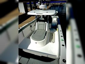 An interior view of a sleek boat helm featuring modern seating and a Garmin navigation system, perfect for a day out on the water.