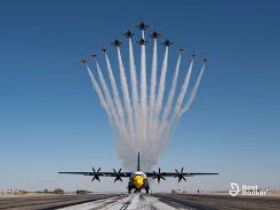 An aerial display featuring multiple aircraft performing a coordinated maneuver, showcasing precision flying and aerial artistry.