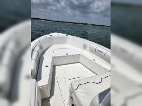 A clean and spacious interior view of a boat, showcasing the seating and helm area, perfect for comfortable outings on the water.