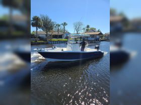 A speedboat navigates through calm waters, showcasing a sunny day on the water — perfect for fishing or leisurely cruises.
