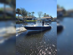 A sleek speedboat navigates through calm waters, showcasing its design and functionality — perfect for thrilling water adventures.