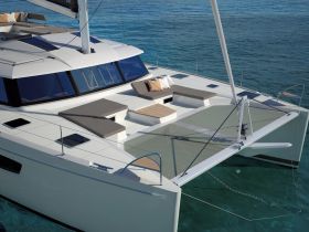 A stunning aerial view of a modern catamaran showcasing its sleek design and spacious deck, perfect for luxury sailing experiences.