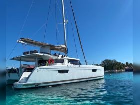 A stunning view of a Saba 50 catamaran docked in crystal-clear waters, perfect for luxury sailing adventures.