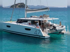 A family enjoys a sunny day aboard a Saona 47 catamaran, showcasing the perfect blend of relaxation and adventure on the turquoise waters.