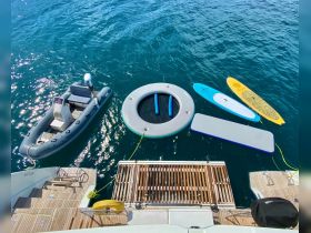 An array of water toys including paddleboards and a floating mat, ready for fun in the sun. Perfect for enhancing your boating experience with leisure activities on the water.