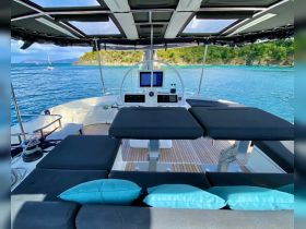 A stylish interior view of a yacht's helm area featuring comfortable seating and modern navigation equipment, perfect for a relaxing day on the water.