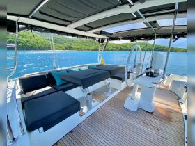 A spacious and stylish interior view of a yacht's helm and seating area, perfect for relaxing and navigating the beautiful waters.