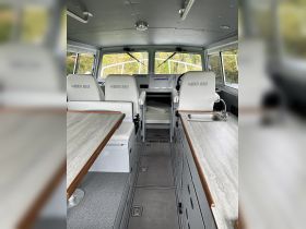 Interior view of a North River boat's helm and seating area, showcasing a spacious and functional design ideal for comfortable navigation.