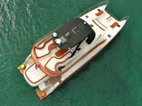 A stunning aerial view of a luxurious yacht anchored in clear turquoise waters, showcasing its elegant design and spacious deck.