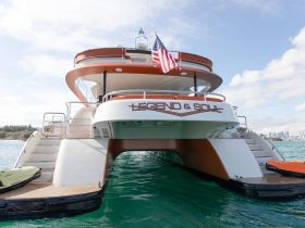 A stunning view of the 'Legend & Soul' yacht, showcasing its elegant design and structure as it glides through clear waters, perfect for luxury charters.