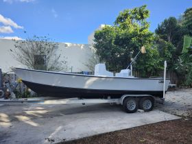 A side view of a boat on its trailer, showcasing its sleek design and ready for transport. Perfect for fishing trips or weekend getaways.