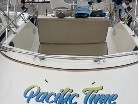 A cozy seating area inside the boat named 'Pacific Time', perfect for relaxing while on the water.