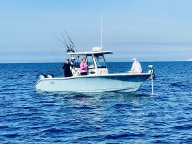 A group of anglers enjoys a fishing trip on a boat, showcasing the excitement of ocean fishing adventures.