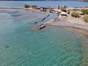 Aerial view of a coastal area with clear waters and a rocky shoreline, but the image lacks clarity and focus.