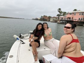 A cheerful group of friends enjoys a day on the water, capturing memories aboard their boat. Perfect for summer outings and fun adventures.