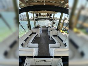 Interior view of a spacious Bennington boat cabin featuring comfortable seating, perfect for relaxing on the water.