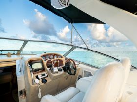 A well-appointed helm of a luxury boat, showcasing the console and seating area, perfect for navigating the open waters.