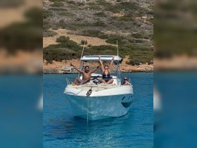 A joyful group celebrates on a boat, enjoying the sun and water — perfect for summer outings and memorable adventures.