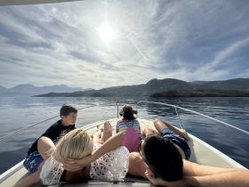 A family enjoys a relaxing day on the boat, soaking in the sun and beautiful scenery — perfect for creating lasting memories on the water.