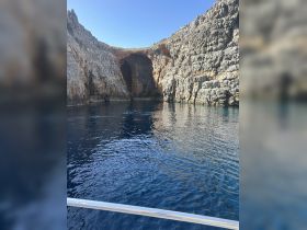 A stunning view of a rocky coastline featuring a natural cave, perfect for exploring the beauty of the sea and surrounding landscapes.