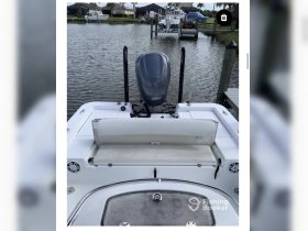 Interior view of a boat's helm and seating area, showcasing the clean and functional design ideal for fishing or leisure outings.