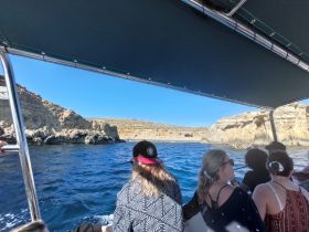A group of guests enjoys a scenic boat tour, navigating through stunning coastal landscapes — perfect for adventure seekers and nature lovers.