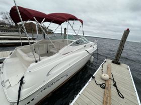 A sleek speedboat is docked at the marina, showcasing its elegant design and ready for the next adventure on the water.