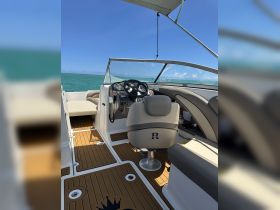 Interior view of a stylish boat helm featuring comfortable seating and a well-equipped dashboard, perfect for navigating the open waters.