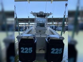 A detailed view of the helm and console area of a boat, showcasing the equipment and layout ideal for navigation and control.