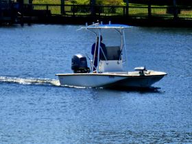 A sleek speedboat navigates through calm waters, showcasing its design and performance. Perfect for water enthusiasts looking for adventure on the waves.