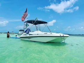A fun day at the beach with a group enjoying the water near a boat, perfect for family outings and aquatic adventures.