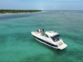 A lively group enjoys time aboard a yacht in stunning turquoise waters, perfect for celebrations and memorable outings on the water.