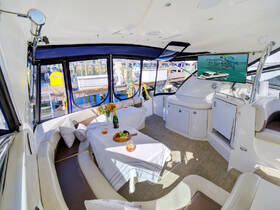 A beautifully designed interior of a boat featuring a cozy dining area with snacks and drinks, perfect for entertaining guests while enjoying the waterfront views.
