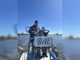 A joyful fishing trip with a family on a boat, showcasing the excitement of outdoor adventures on the water.