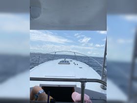 A view from the helm of a boat, showcasing the interior space and steering area, perfect for navigating the open waters.