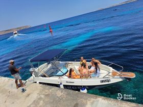 A lively group enjoys a sunny day on a boat, capturing the essence of summer fun and outdoor adventures on the water.