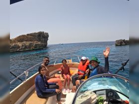 A joyful family enjoys their time on a boat, surrounded by stunning ocean views — perfect for memorable adventures and family bonding.