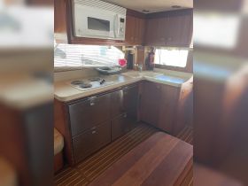 A well-equipped boat kitchen featuring modern appliances and ample storage, perfect for preparing meals while on the water.