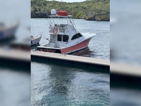 A fishing boat named 'WAZAPAD' docked in calm waters, showcasing its sleek design and readiness for adventure.