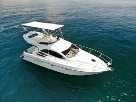 A stunning aerial view of a sleek yacht cruising through crystal-clear waters, perfect for luxury charters and seaside adventures.