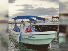A group of friends enjoys a scenic boat ride at sunset, creating memorable moments on the water.