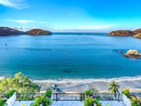 A stunning view of a tranquil coastline with islands in the distance, perfect for showcasing the beauty of nature and ideal for vacation destinations.