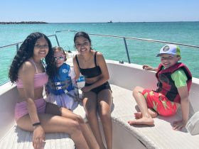 A joyful group of children enjoys a sunny day on a boat, showcasing the fun and excitement of family boating adventures.