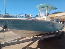 A sleek speedboat displayed on a trailer, showcasing its vibrant design and ready for adventure on the water.