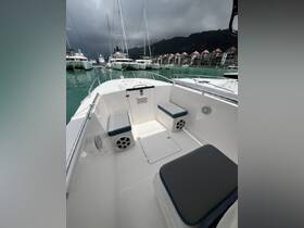 A clean and spacious interior view of a boat featuring comfortable seating and a helm area, perfect for enjoying a day on the water.