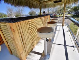 A well-designed bar area on a boat featuring comfortable seating, perfect for enjoying drinks while cruising. Ideal for social gatherings and relaxation on the water.