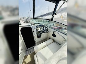 A well-appointed helm area of a boat featuring a comfortable seating arrangement and modern controls, perfect for navigating the open waters.
