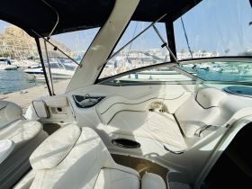 Interior view of a stylish boat cabin featuring comfortable seating and a sleek design, perfect for relaxing on the water.