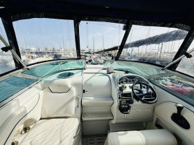 Interior view of a sleek boat helm featuring comfortable seating and modern controls, perfect for navigating the open waters.