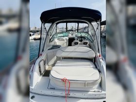 Inside view of a sleek boat cabin showcasing comfortable seating and helm area, perfect for relaxing while cruising the waters.